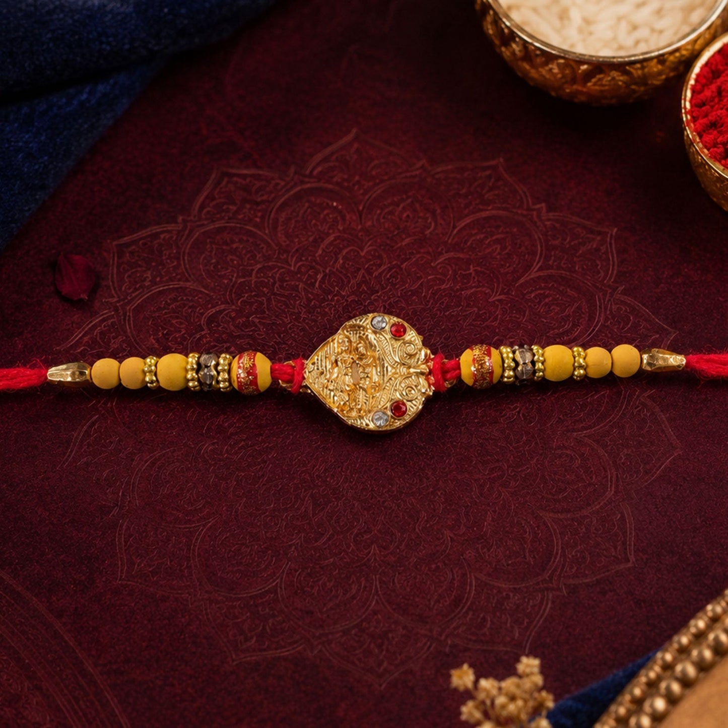Top view of festive Golden Tone Rakhi highlighting design