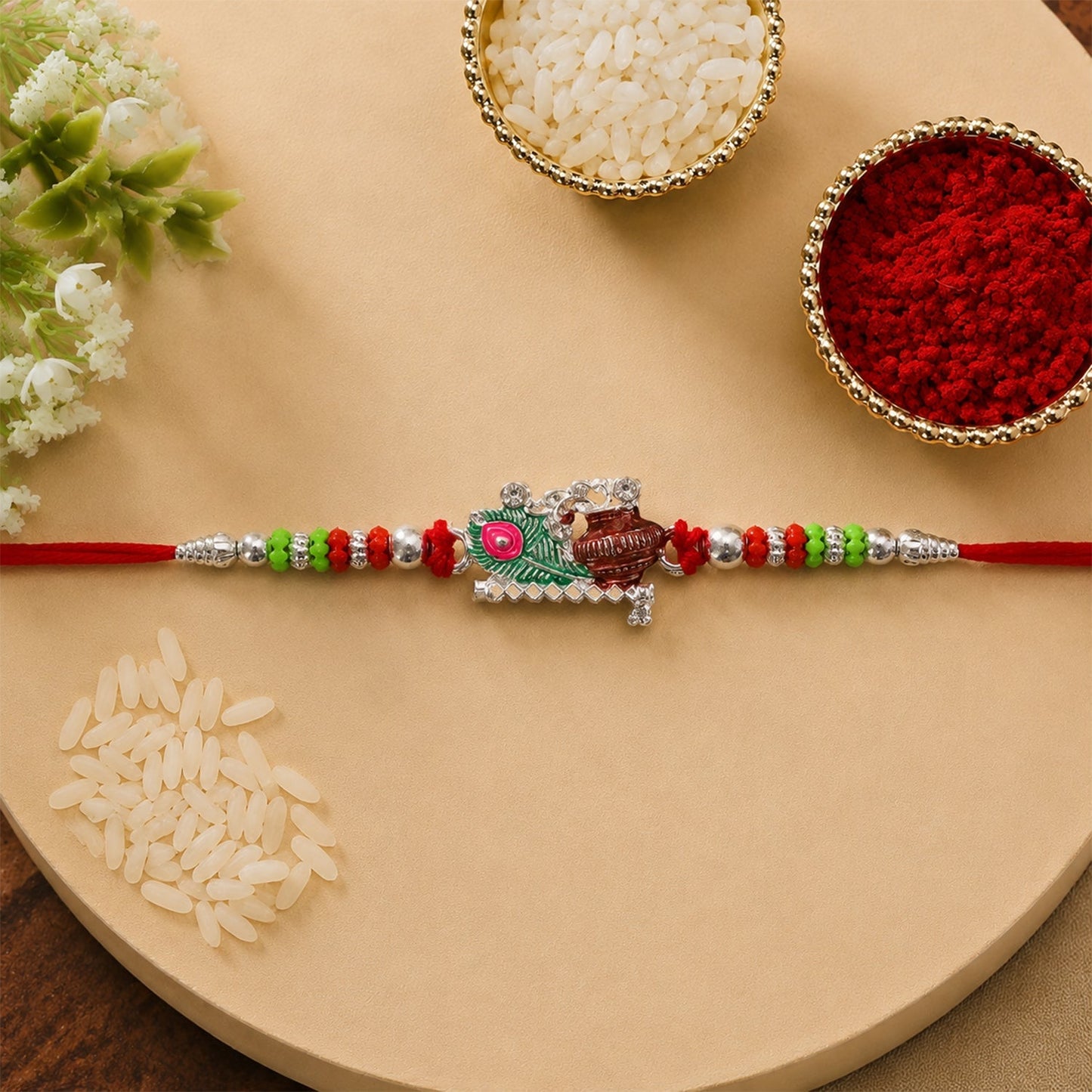 Side view of Krishna Matki Rakhi with beadwork & peacock feather
