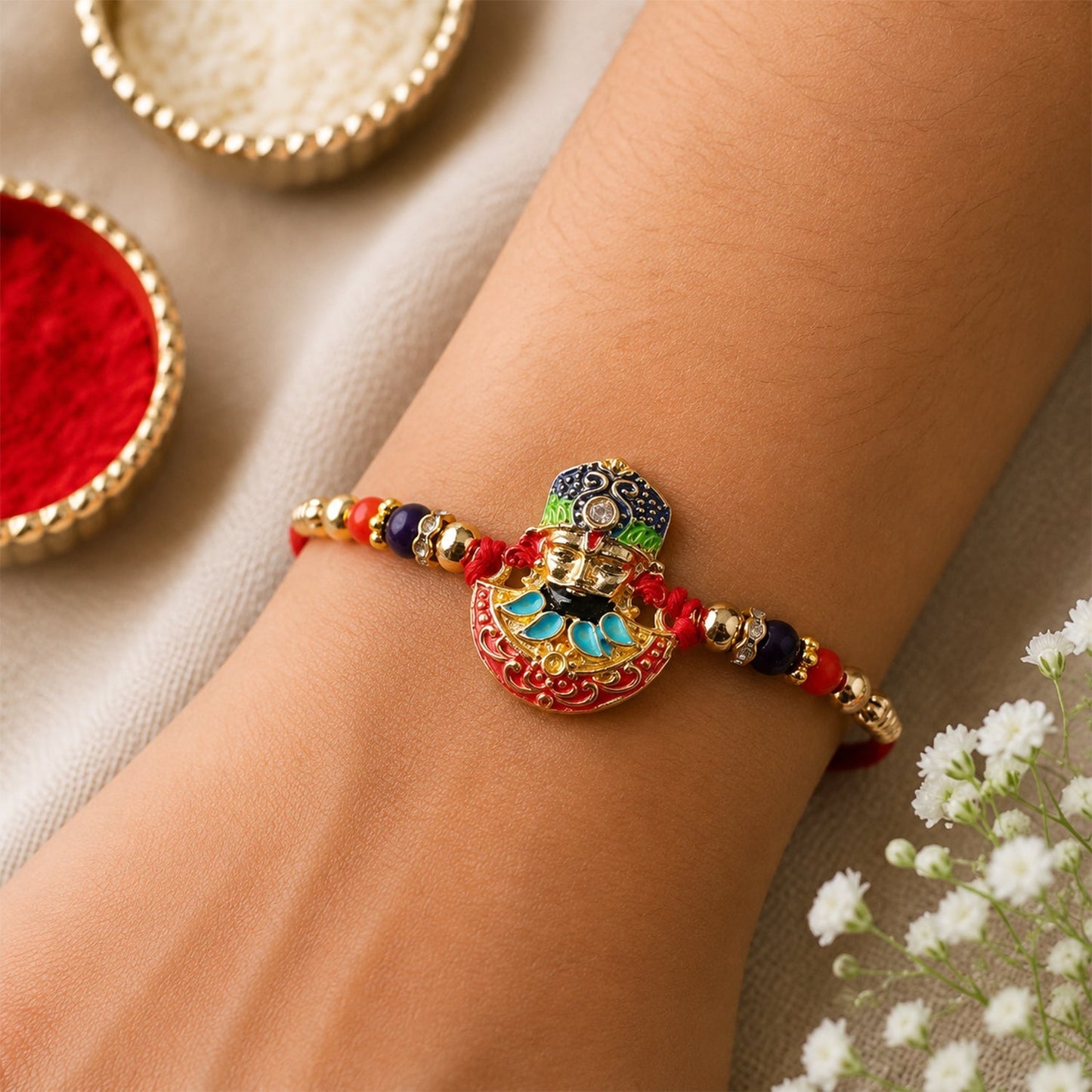 Close-up of vibrant multicolor enamel design on traditional rakhi with gold accents