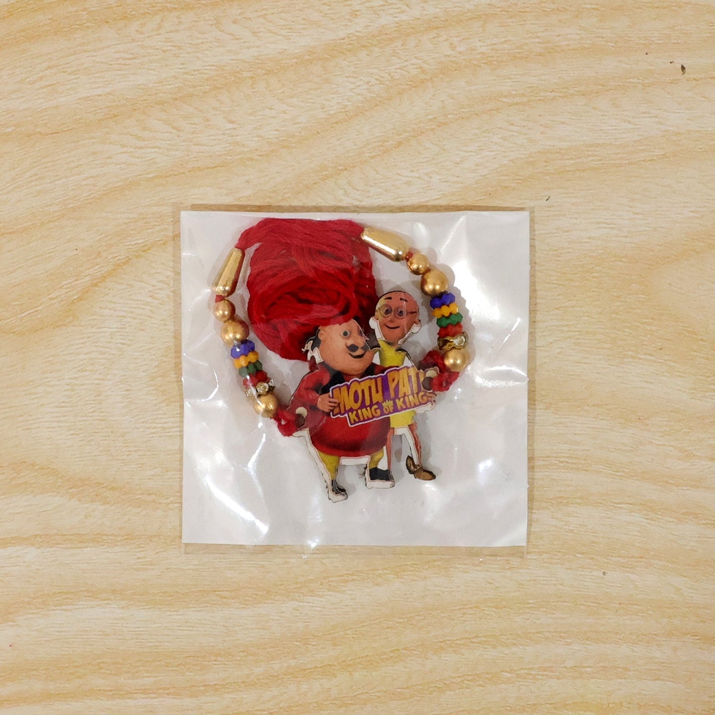 Joyful cartoon motif rakhi with vibrant beads for Rakshabandhan occasions