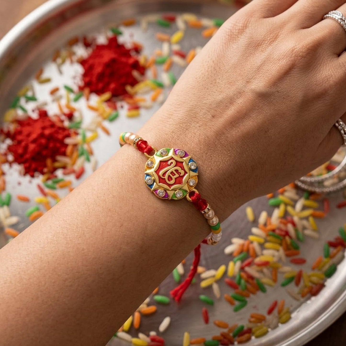 Top view of the meenakari designer rakhi showcasing round pattern