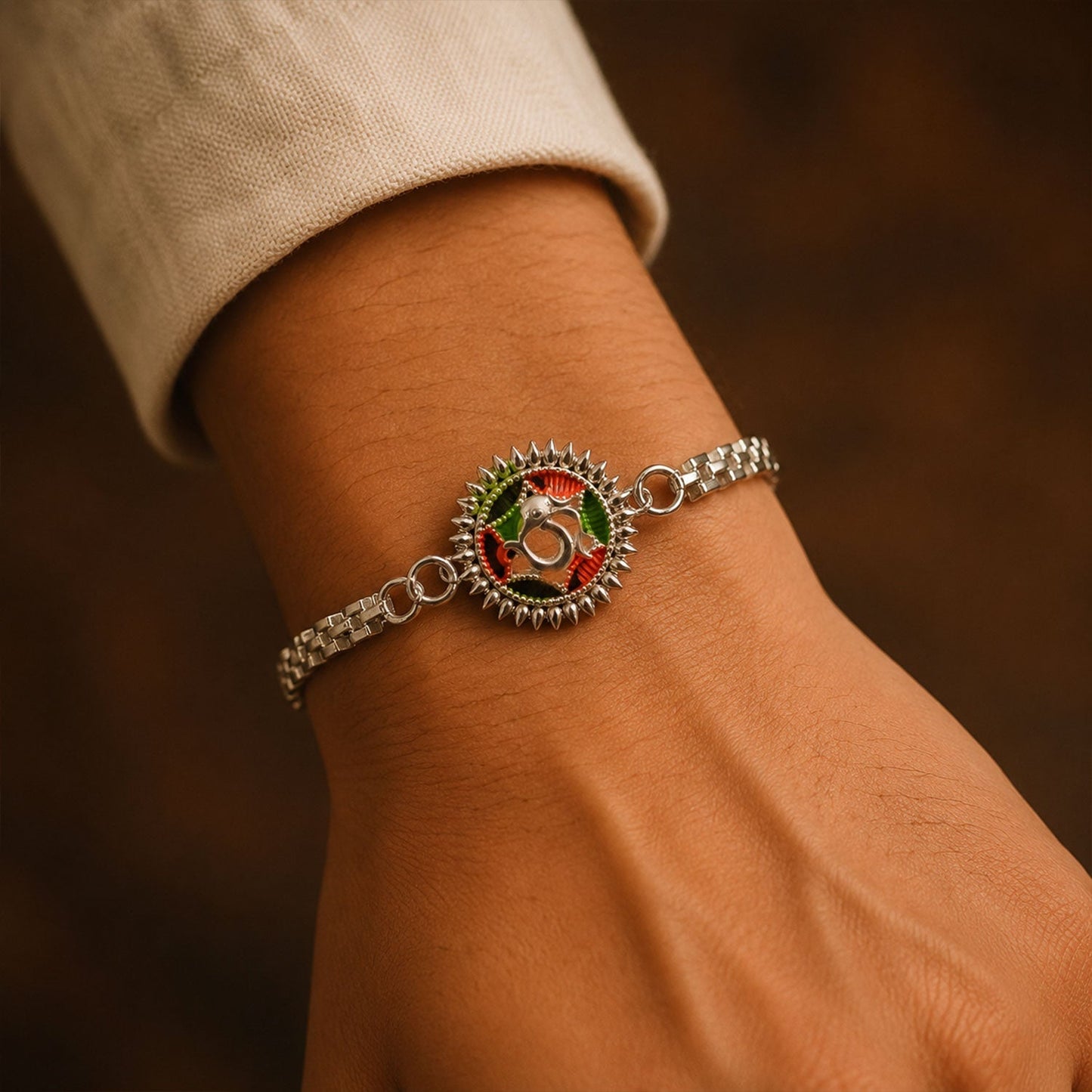 Close-up of Silver Oxidized Om Rakhi with Sunray Meenakari work