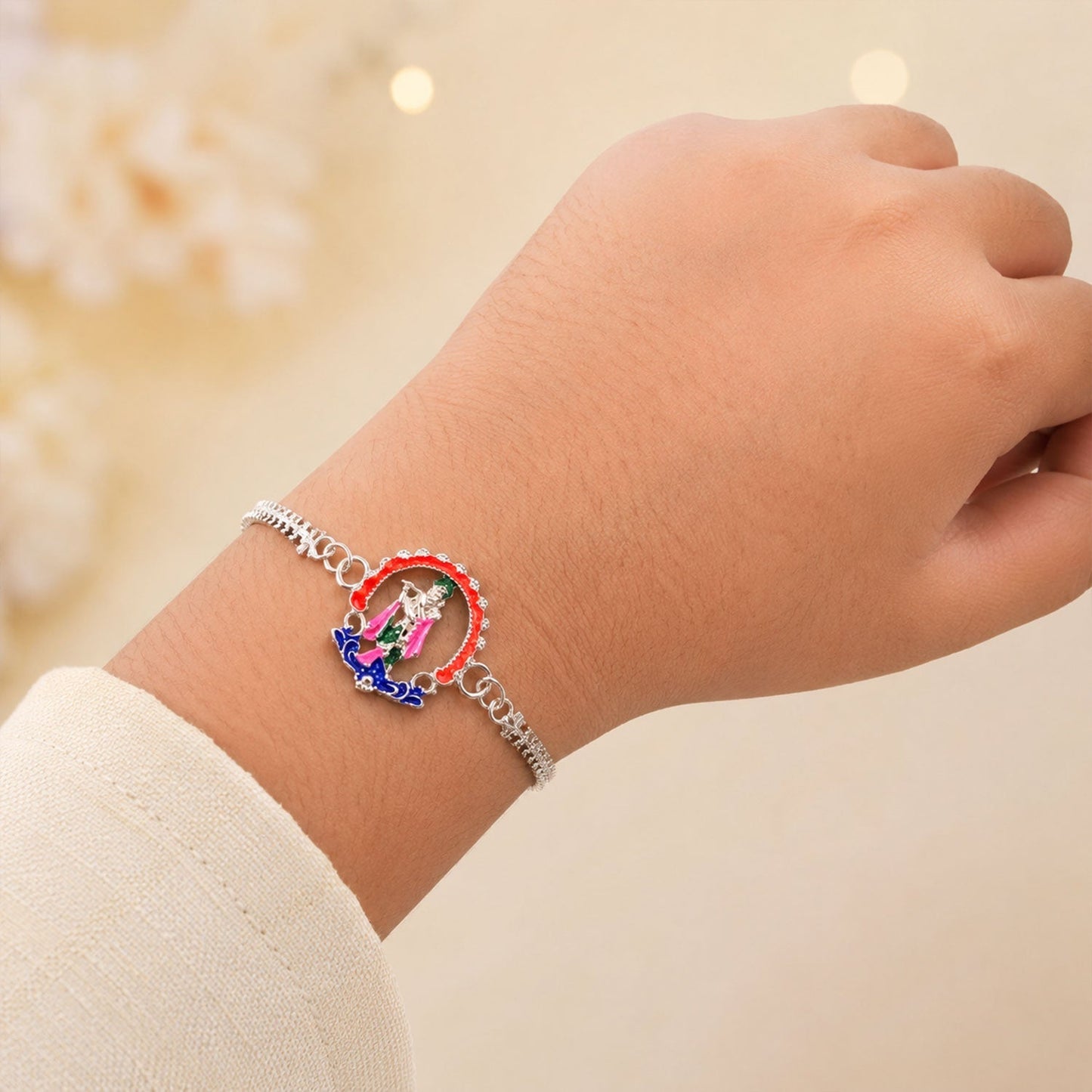 Silver Krishna Rakhi tied on a brother's wrist for Raksha Bandhan