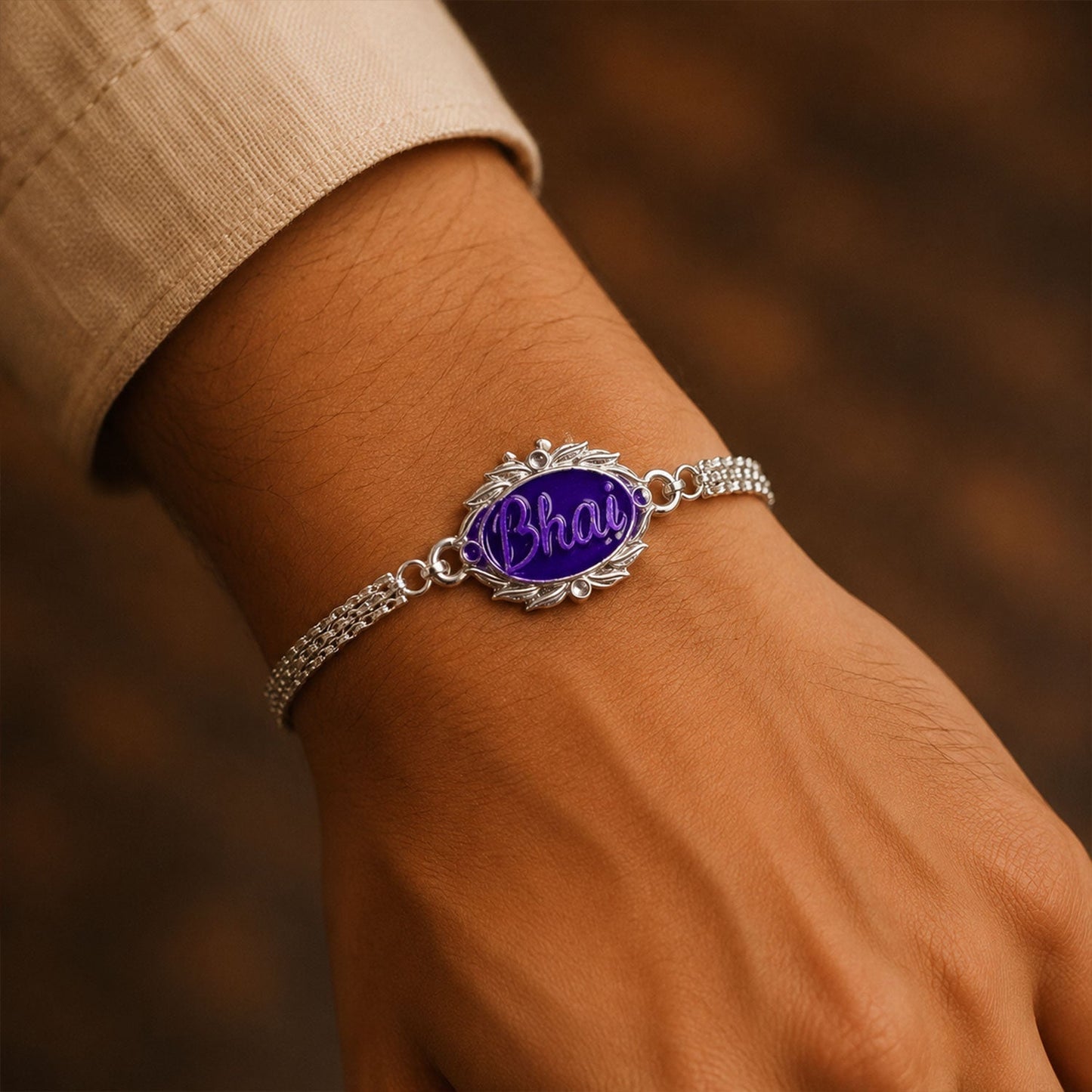 Designer Silver Rakhi tied on a brother’s wrist, festive occasion.