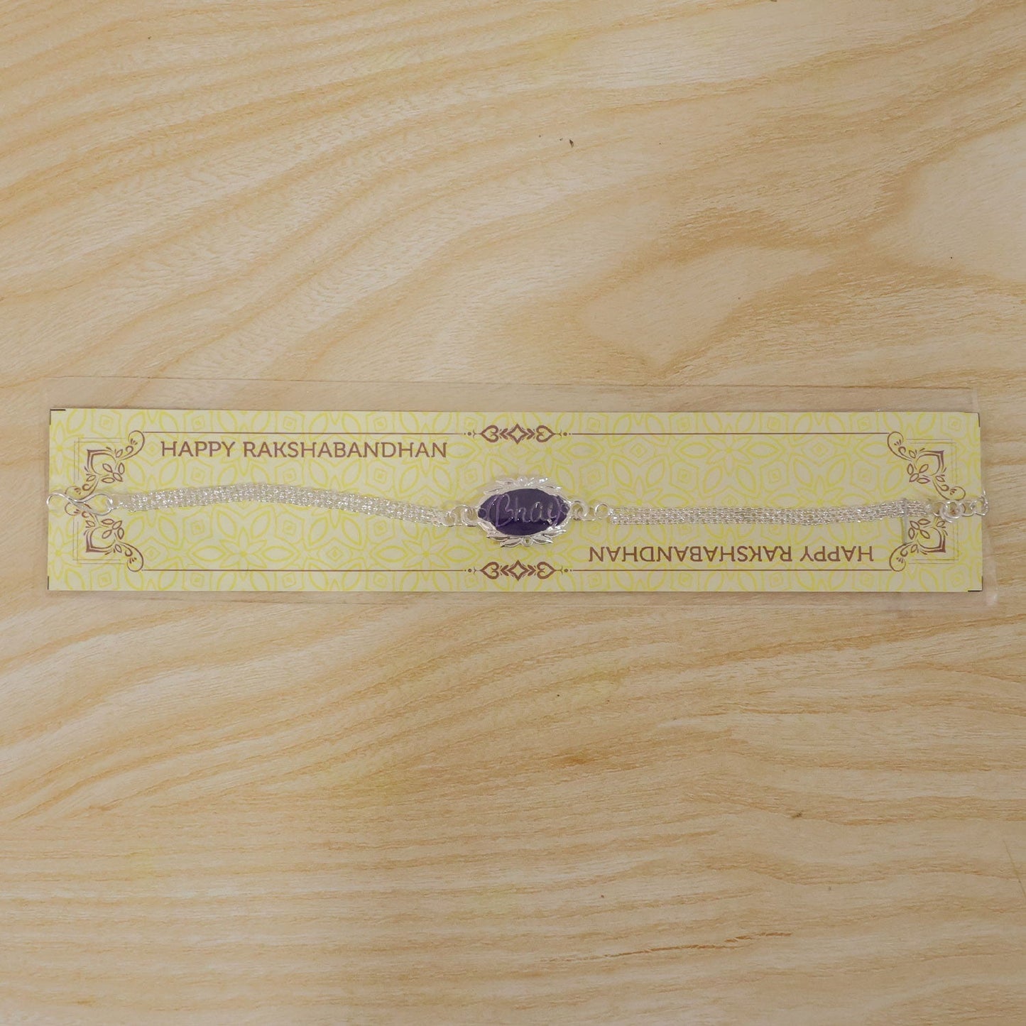 Silver Rakhi displayed with festive decor, perfect for Rakshabandhan.
