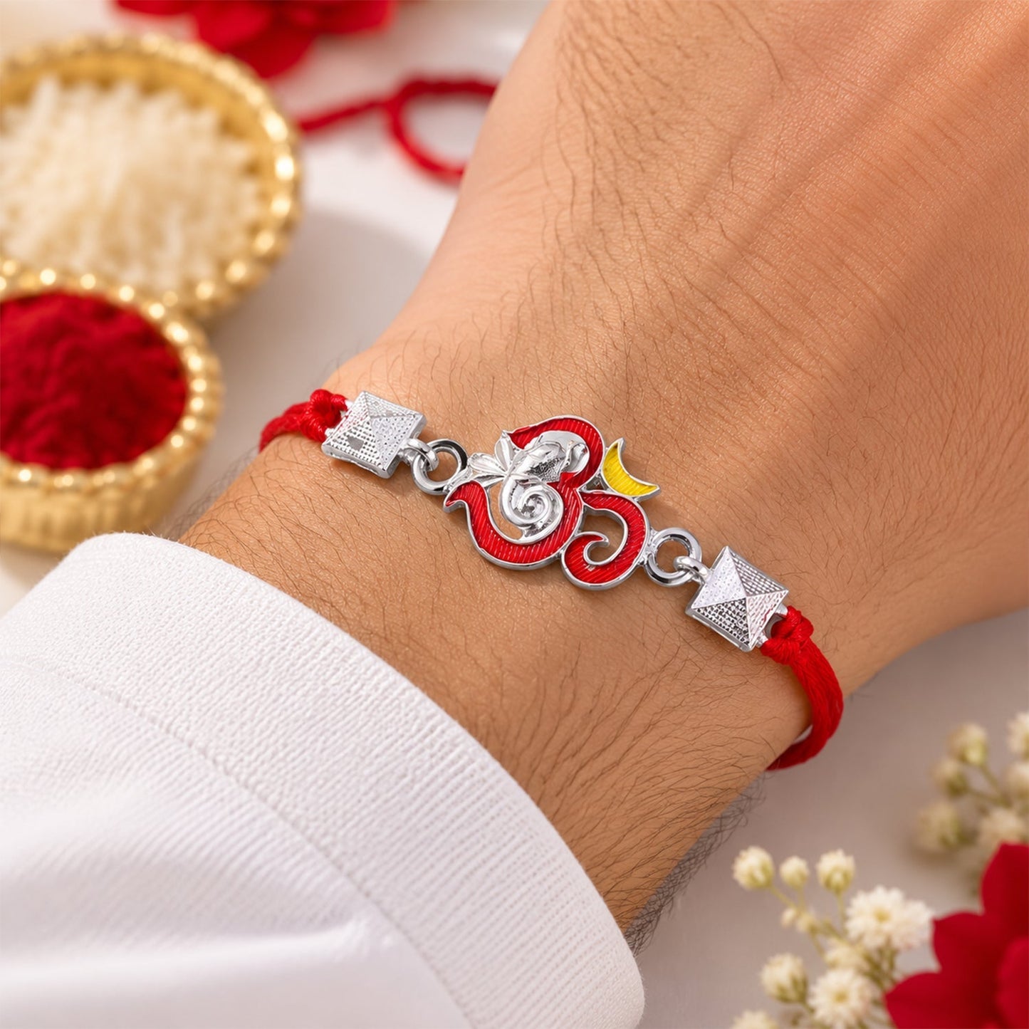 Decorative silver Ganesha Rakhi with pyramid bead design and colorful enamel accents