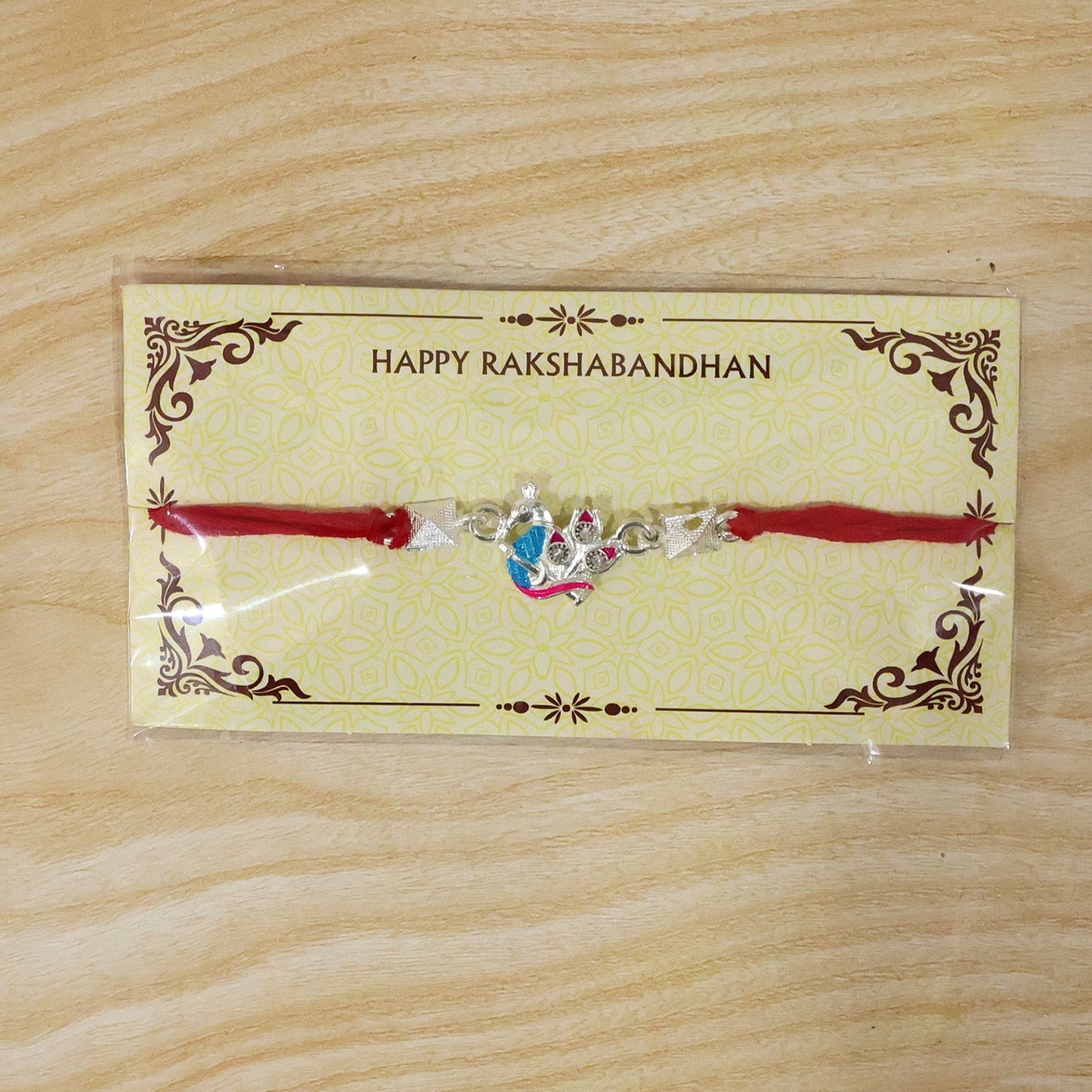 Vibrant silver peacock Rakhi in traditional style for sibling celebration