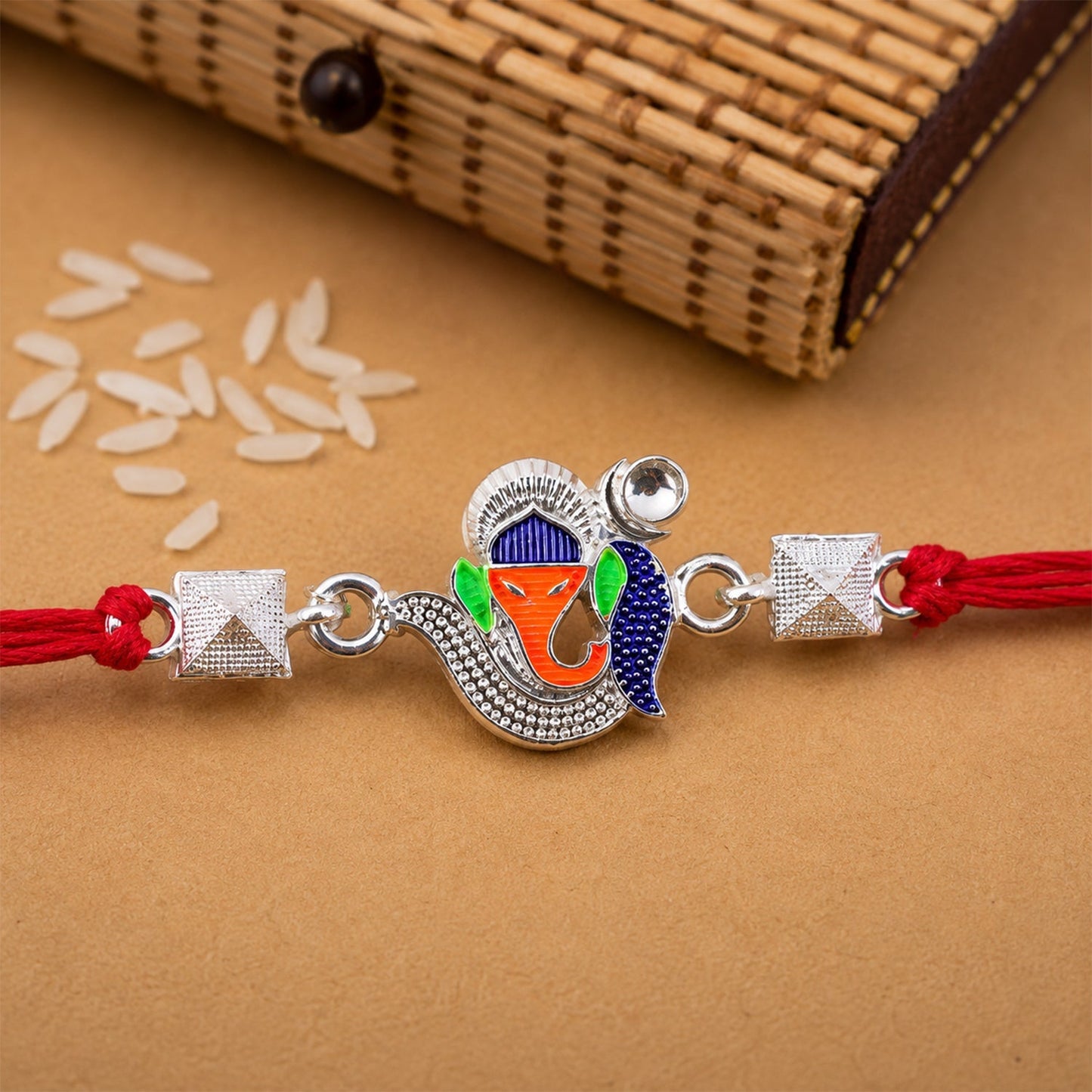 Elegant Silver Ganesha Rakhi with vibrant enamel details