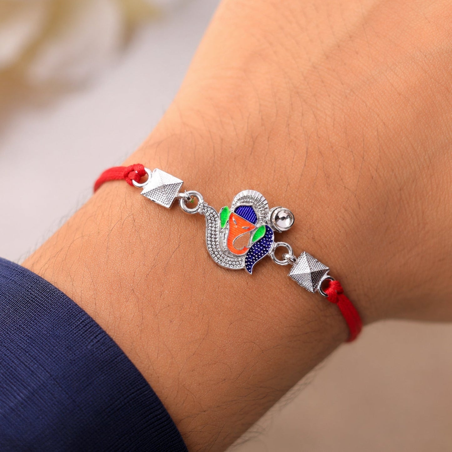 Decorative Silver Ganesha motif Rakhi for brothers