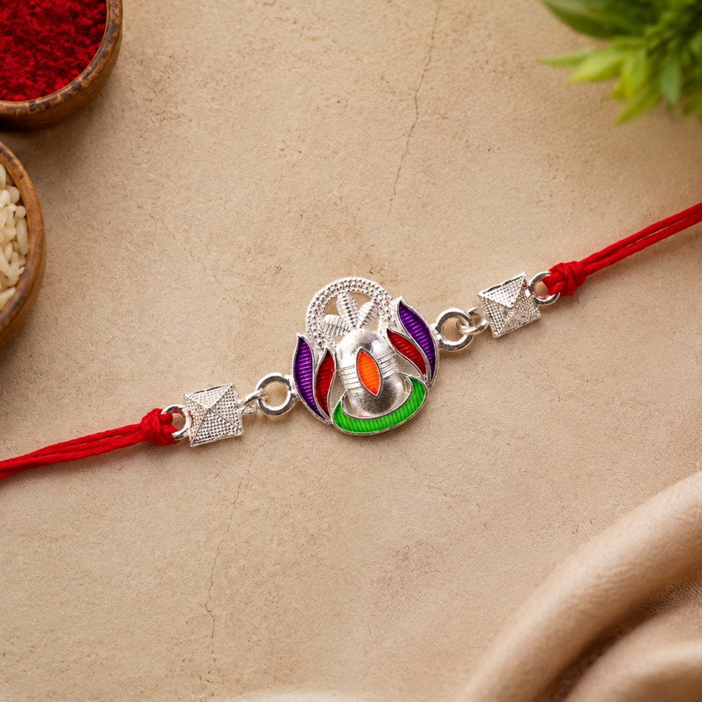 Elegant Silver Shivling Rakhi with shiny silver beads and vibrant colors