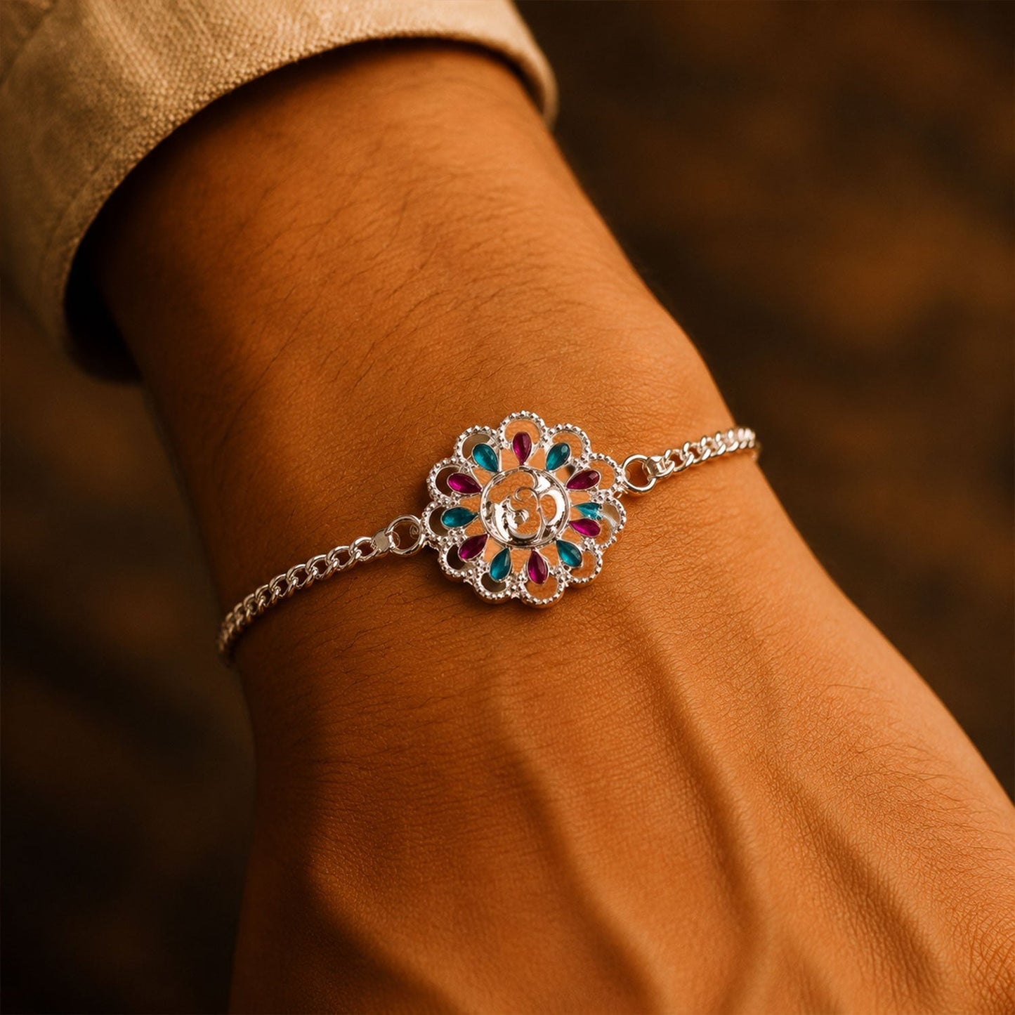 Styling shot of Silver floral Om enamel bracelet for Rakhi