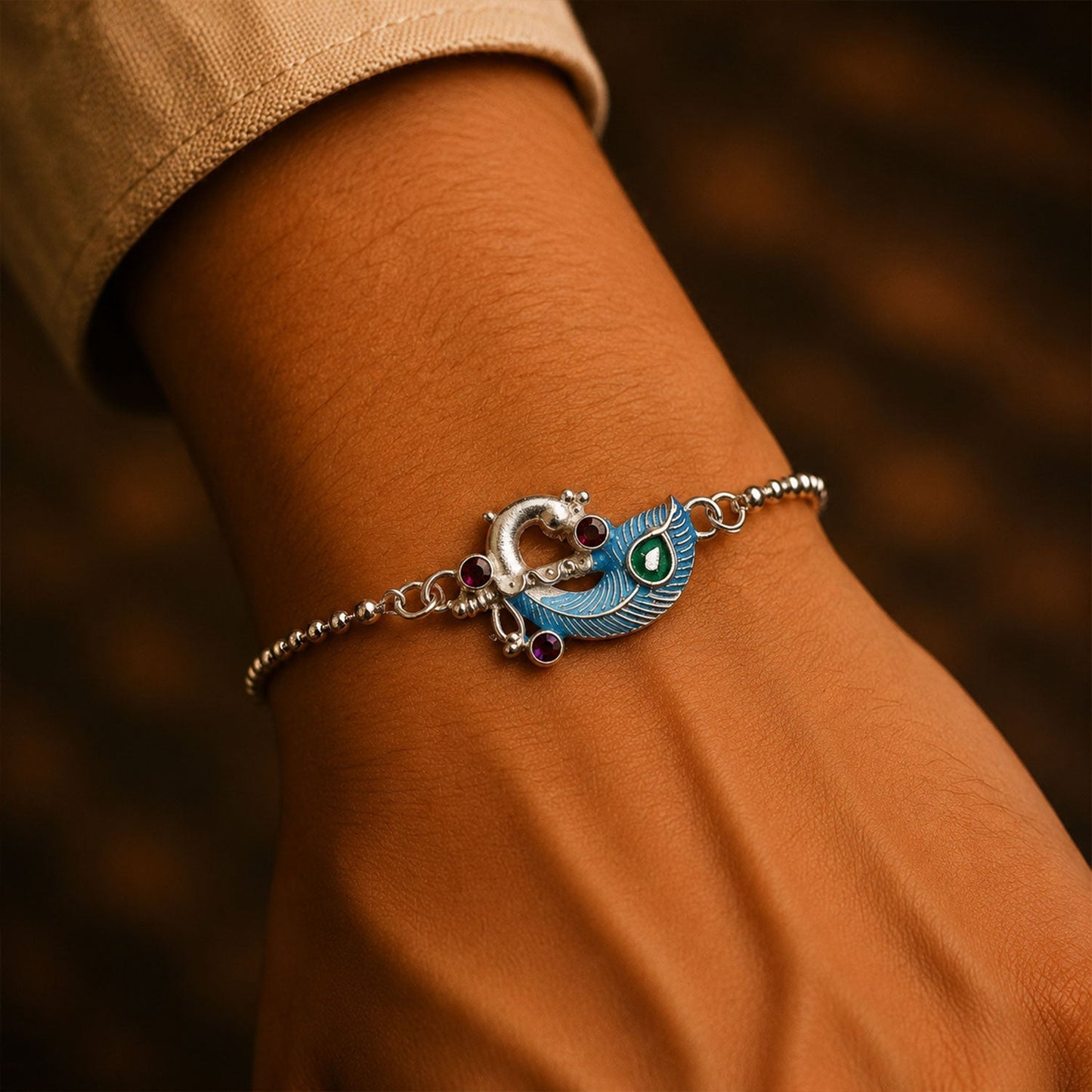 Close-up of colorful enamel and silver design on the Raksha Bandhan bracelet.