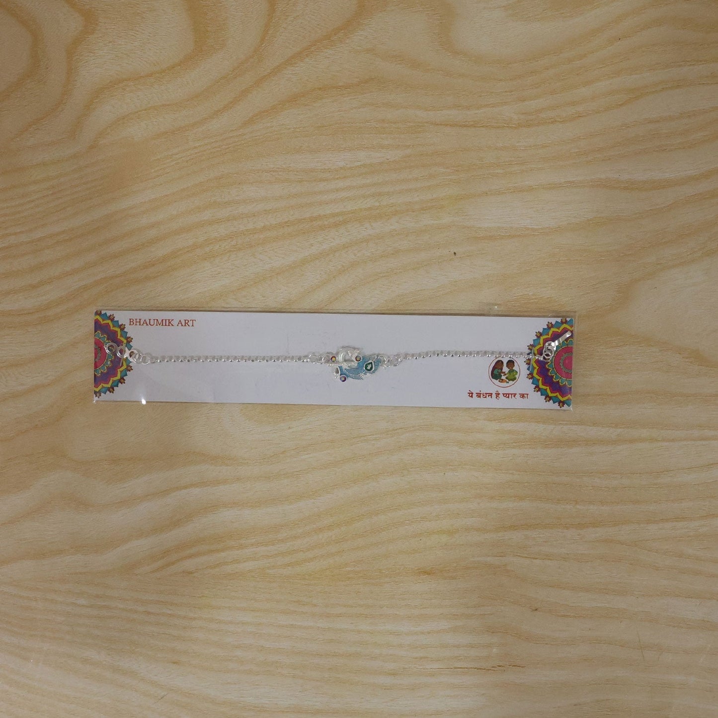 Fashionable silver peacock bracelet with colorful enamel, ideal for Rakhi celebrations.