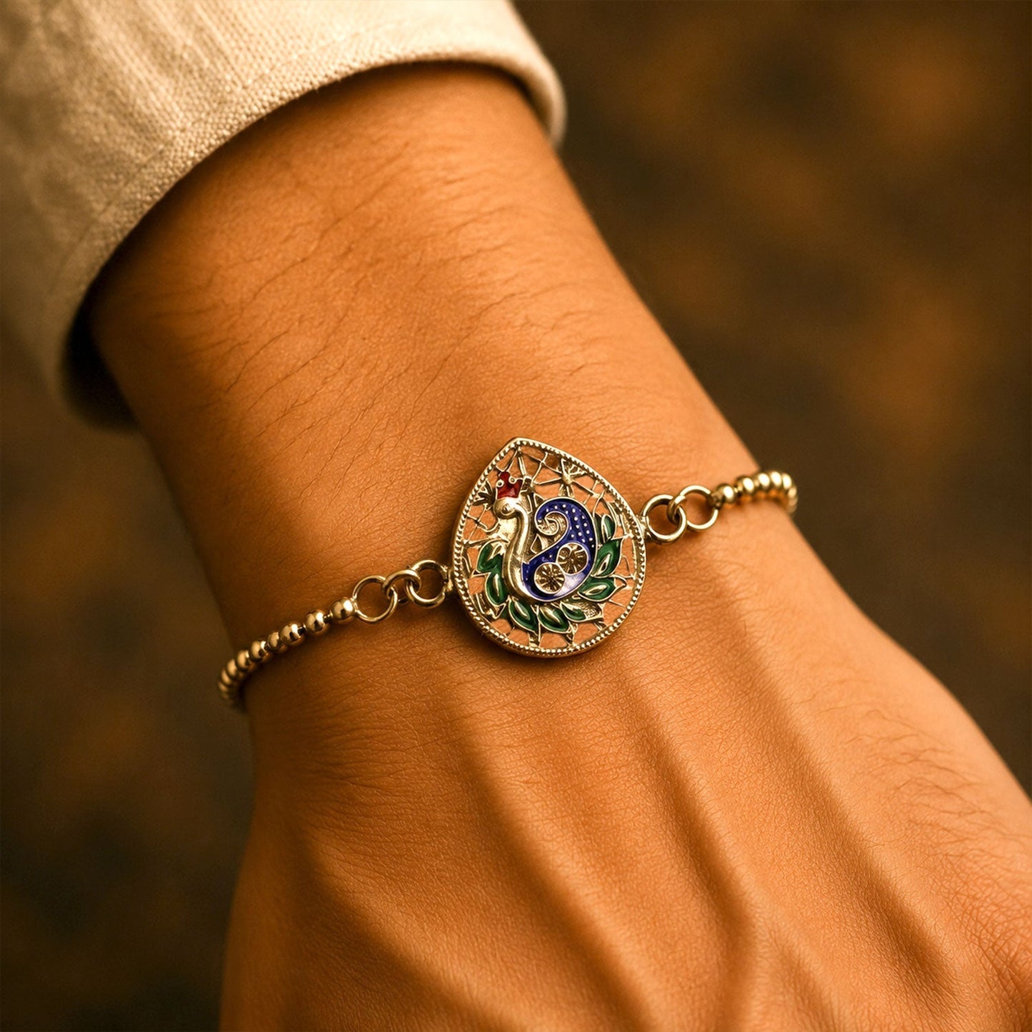 Close-up of colorful enamel peacock motif on traditional chain bracelet
