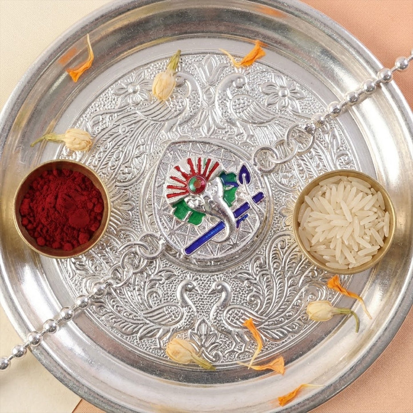 Decorative Lord Ganesha rakhi with vibrant enamel finish for brothers