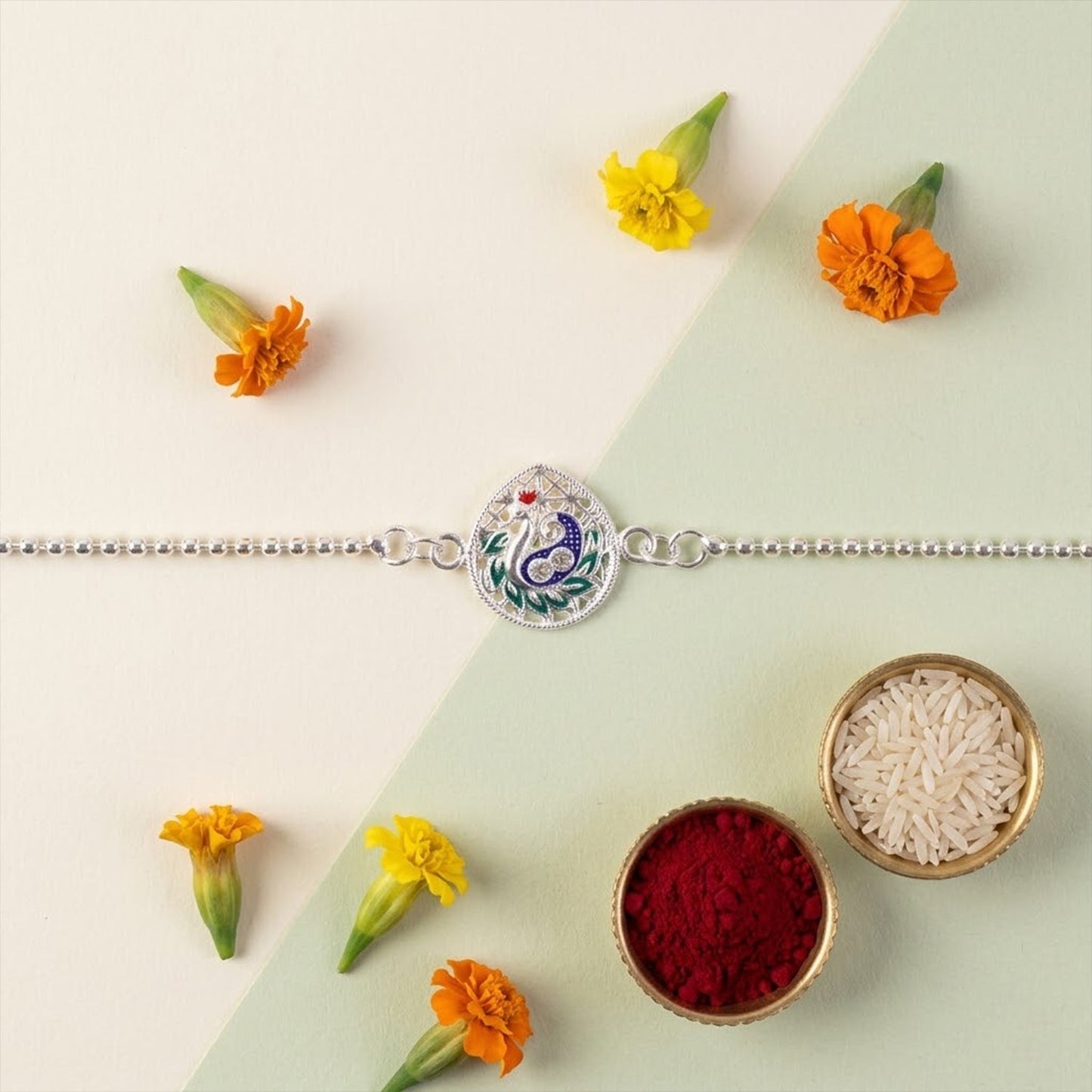 Elegant festive Rakhi with peacock teardrop enamel design