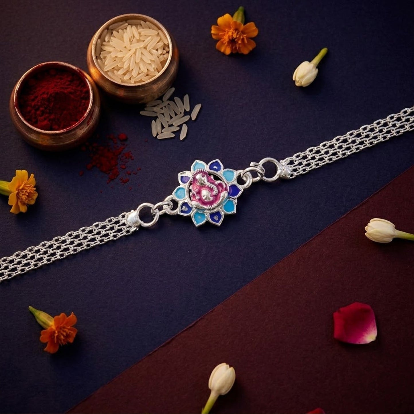 Close-up of Lord Ganesha floral enamel charm on a chain Rakhi