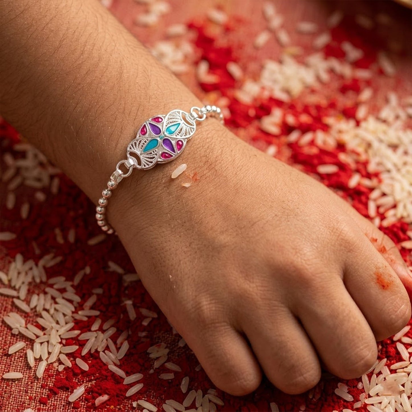 Stylish and vibrant enamel stone charm chain bracelet rakhi for brother, ideal for festival gifting.