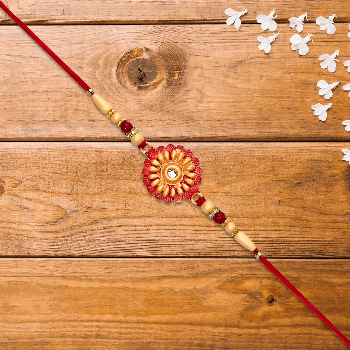 Close-up of floral bead rakhi with central stone showing intricate design