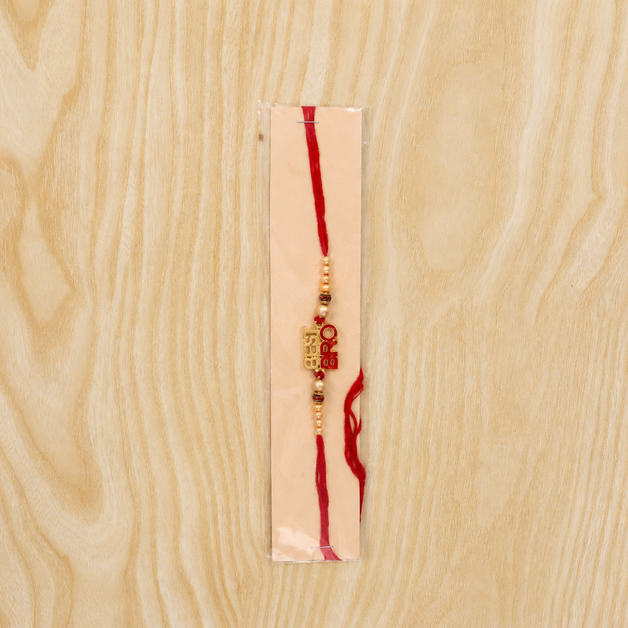 Designer rakhi with pearls and gold lettering for brother on Rakshabandhan