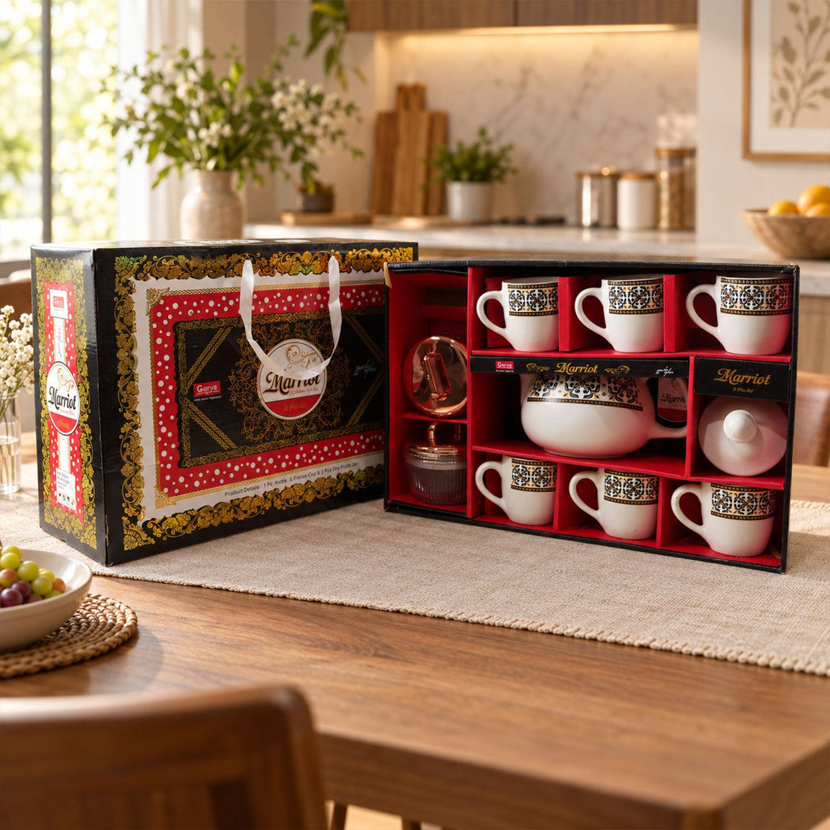 A Marriot gift box, open to reveal a tea set with six cups, a teapot, and two small jars, on a wooden table.