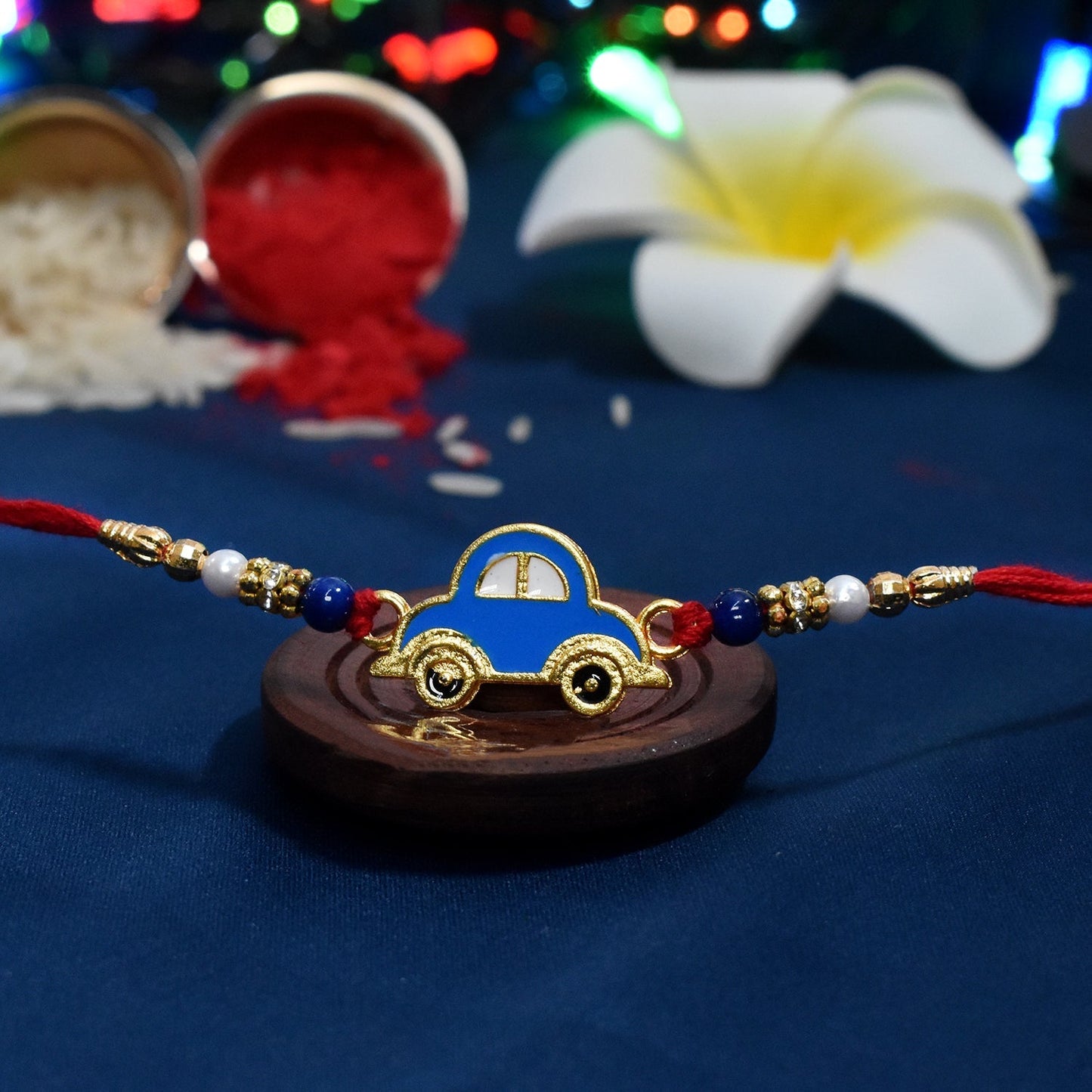 Close-up view of handmade Blue Car Rakhi showcasing detailed playful design for children.