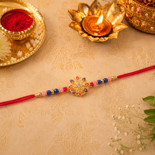 Elegant floral Rakhi with beads on white surface