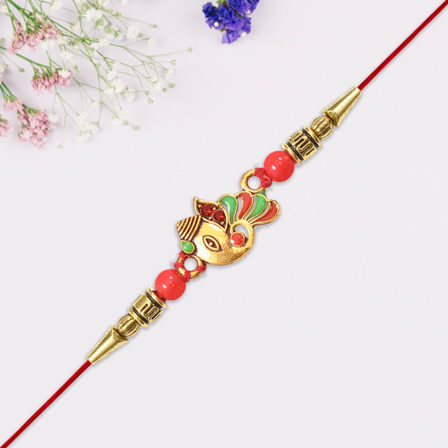 Beautiful Ganpati Rakhi on a spiritual backdrop reflecting prosperity and success.