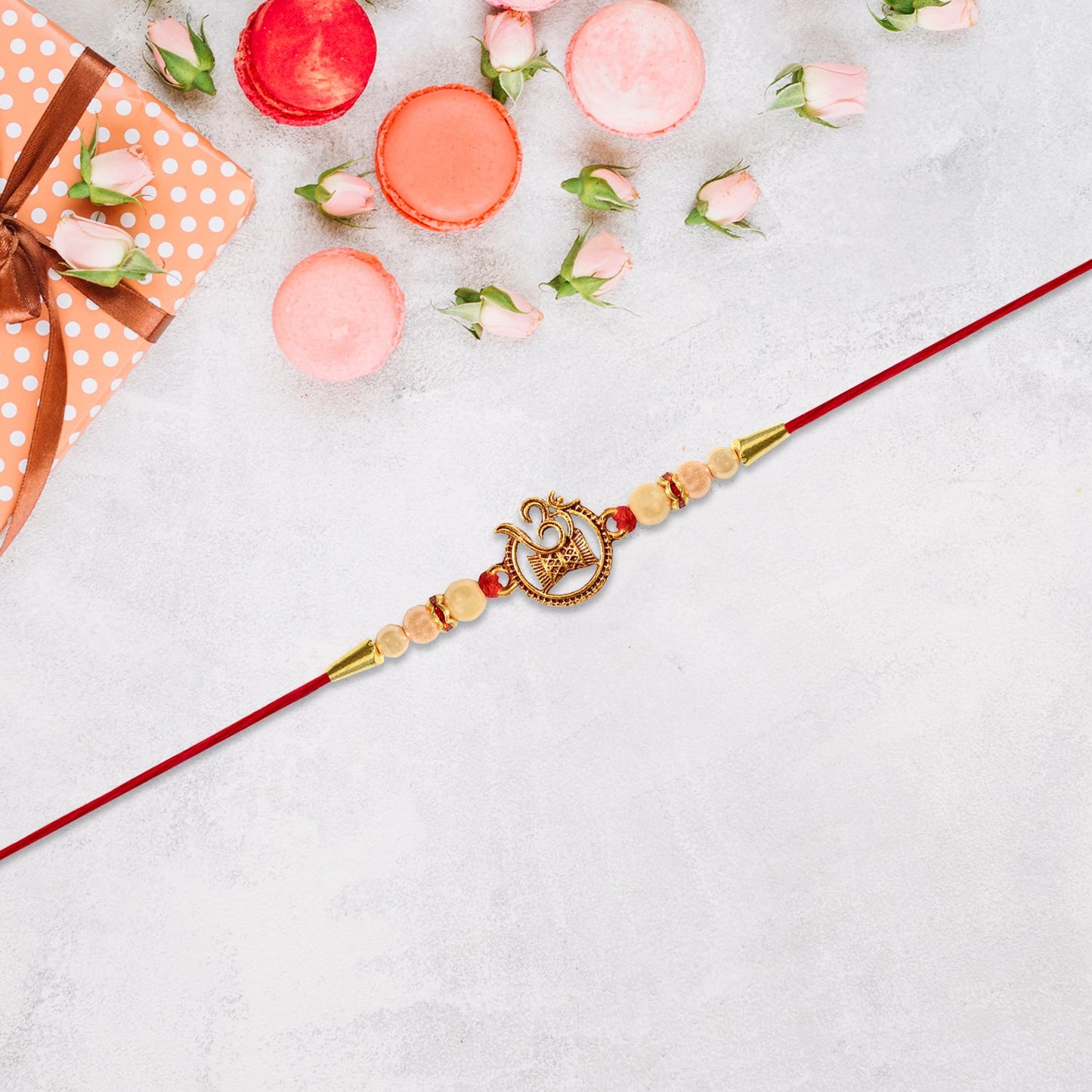 Close-up of golden Om Swastik motif on designer Rakhi