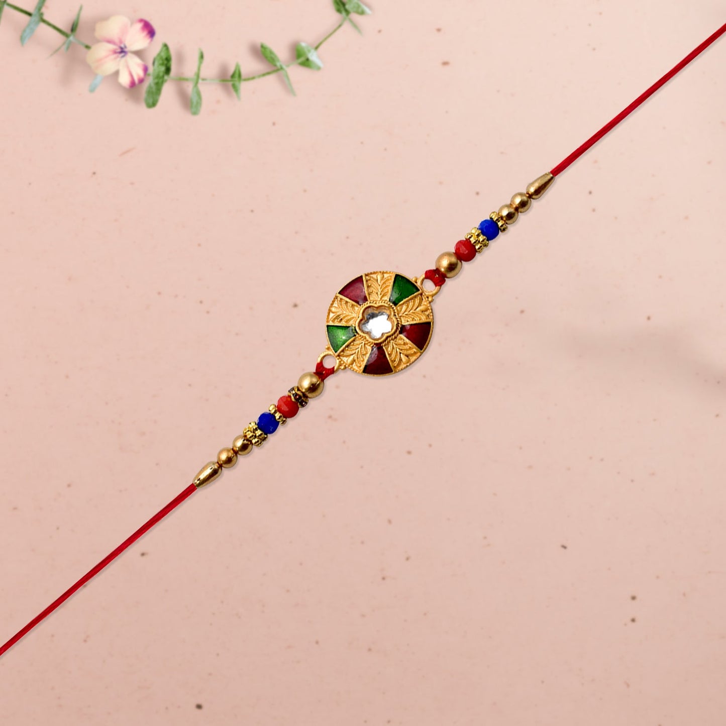 Intricate kundan work detail on traditional multicolor rakhi