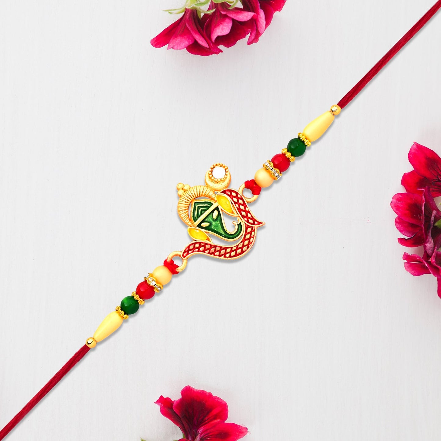 Traditional Ganpati Rakhi featuring spiritual Ganesha pendant with decorative beads