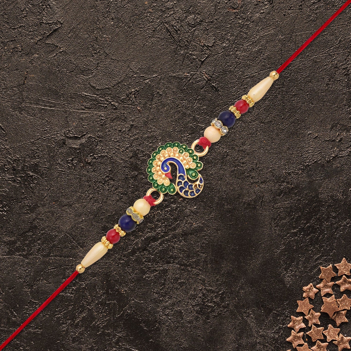 Close-up of golden rakhi with intricate traditional design