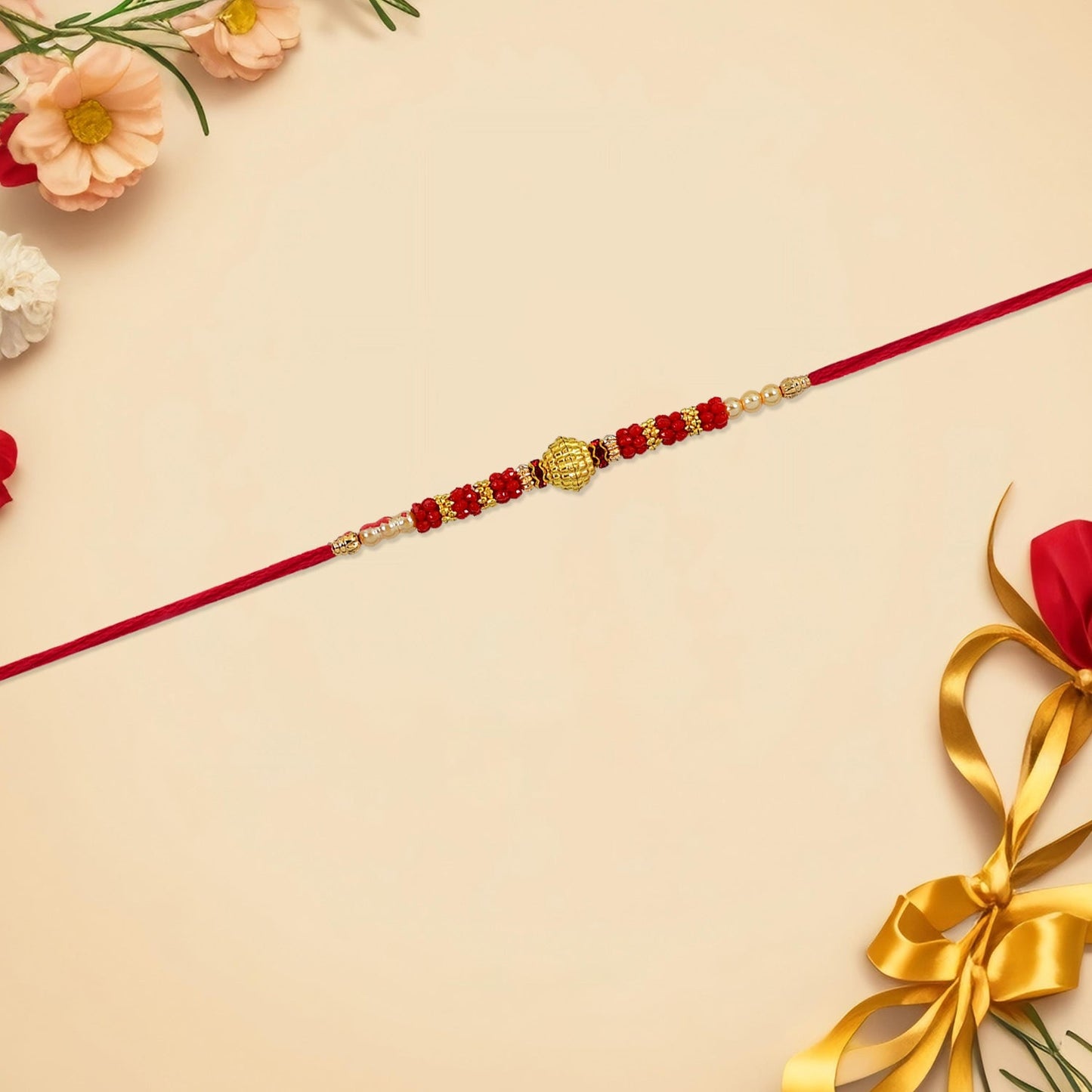 Handcrafted Red Bead Rakhi with a golden centerpiece on white background