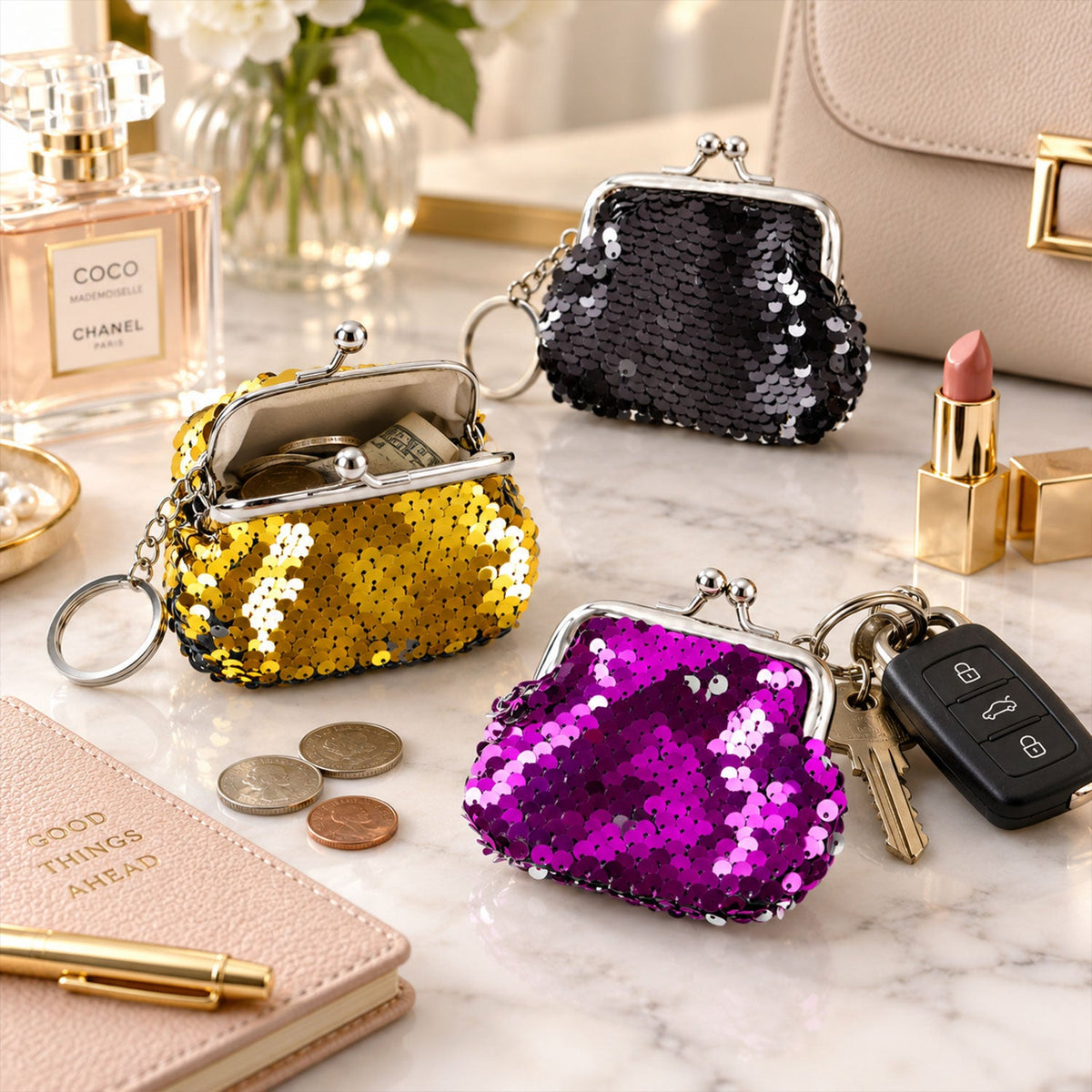 A gold sequined coin purse with coins inside, a black one, and a purple one with keys, on a white surface.