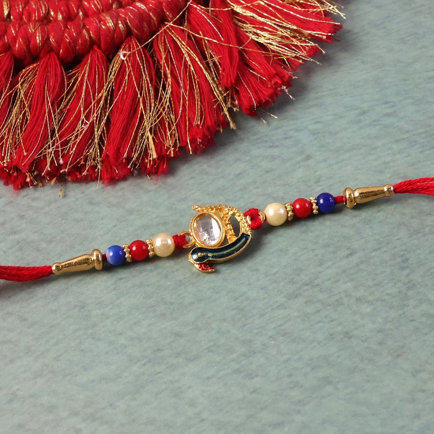 Traditional Rakhi with golden finish beads and stylish design