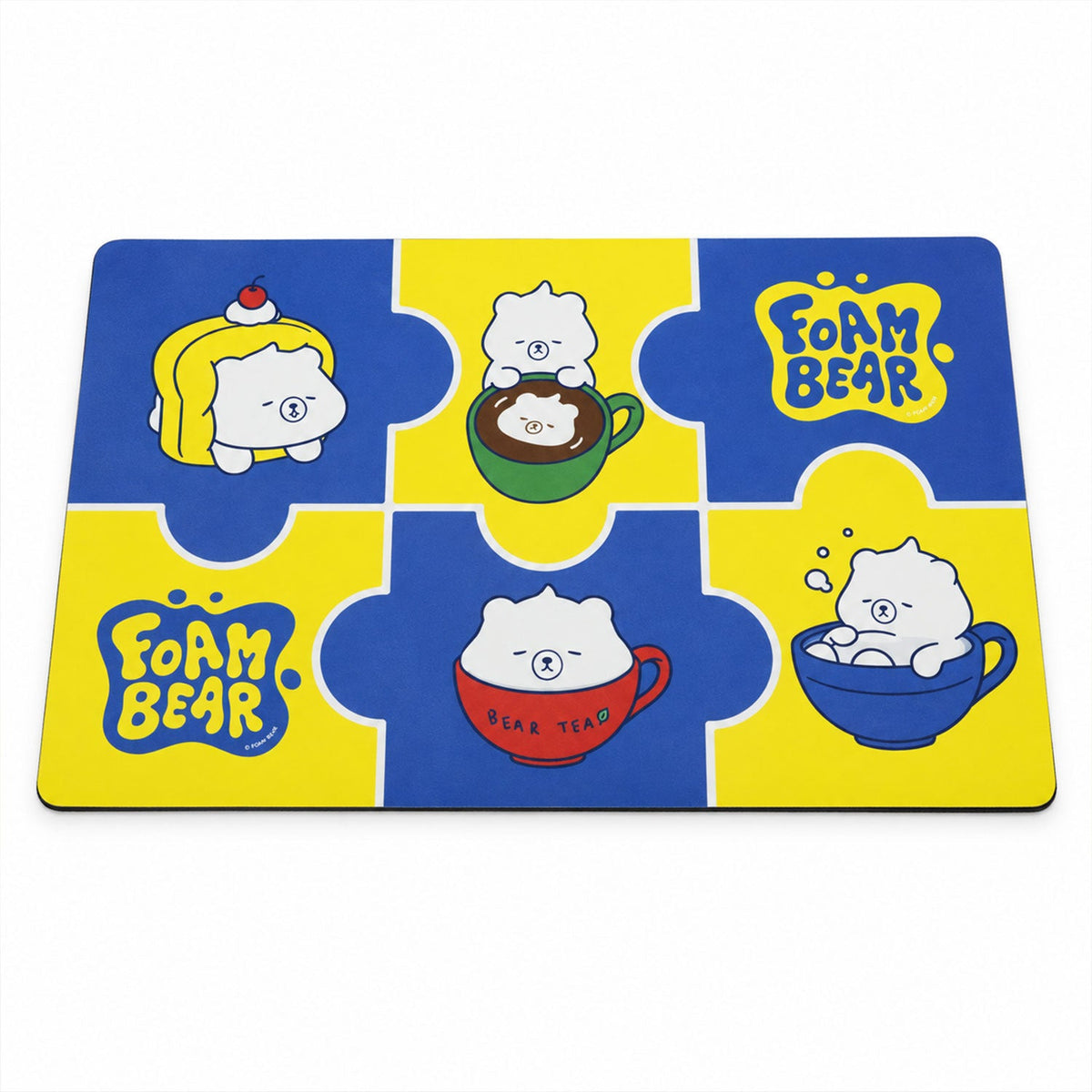 A rectangular blue and yellow bath mat with cartoon bear designs is displayed flat against a white background.