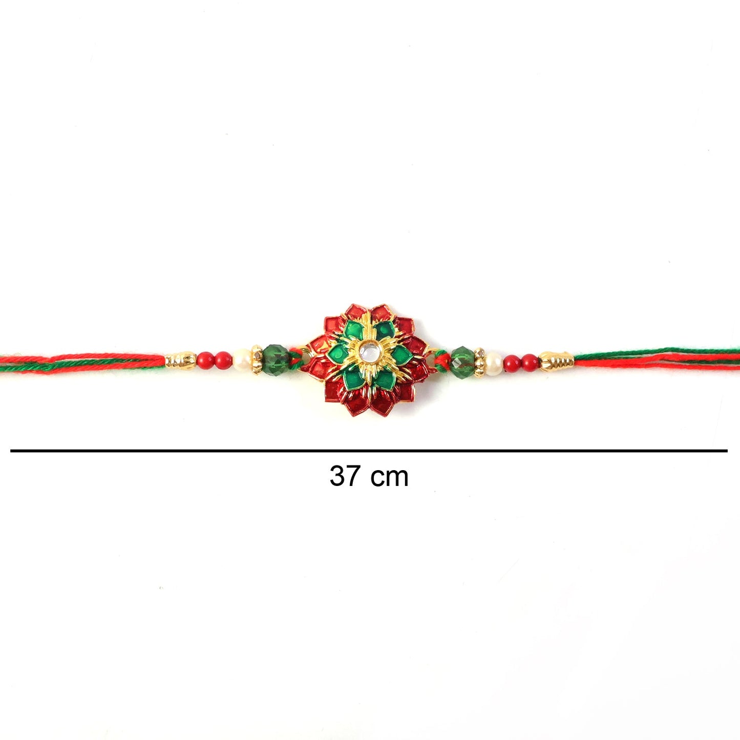 Hand holding floral stone work Rakhi with colorful threads