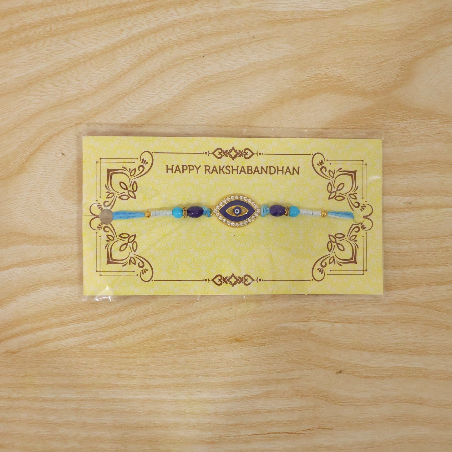 Decorative Rakhi with blue beads and soft thread detail