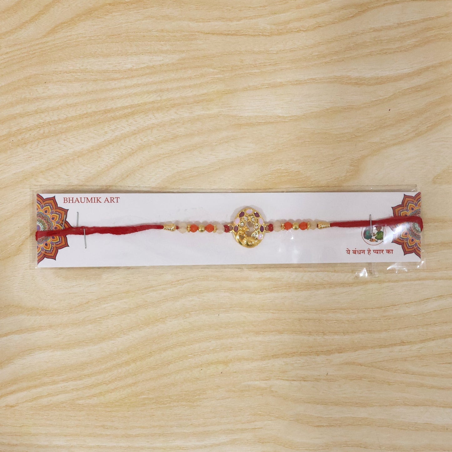 Close-up of designer Peacock Rakhi with colorful beads and intricate design