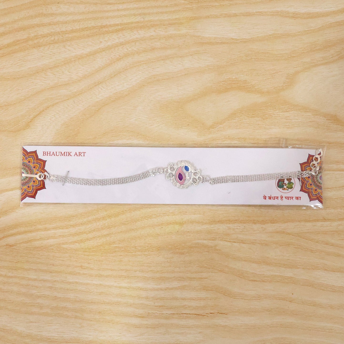 Detailed peacock-themed Rakhi bracelet enhancing sibling bond