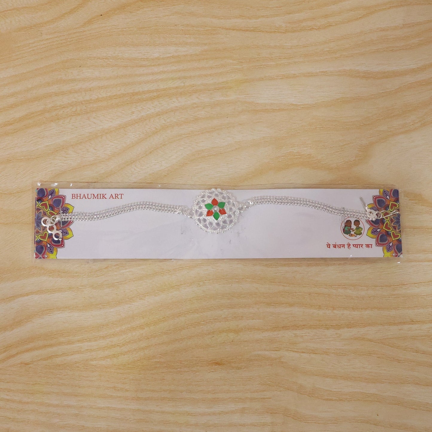 Traditional silver floral Rakhi with beads and elegant design