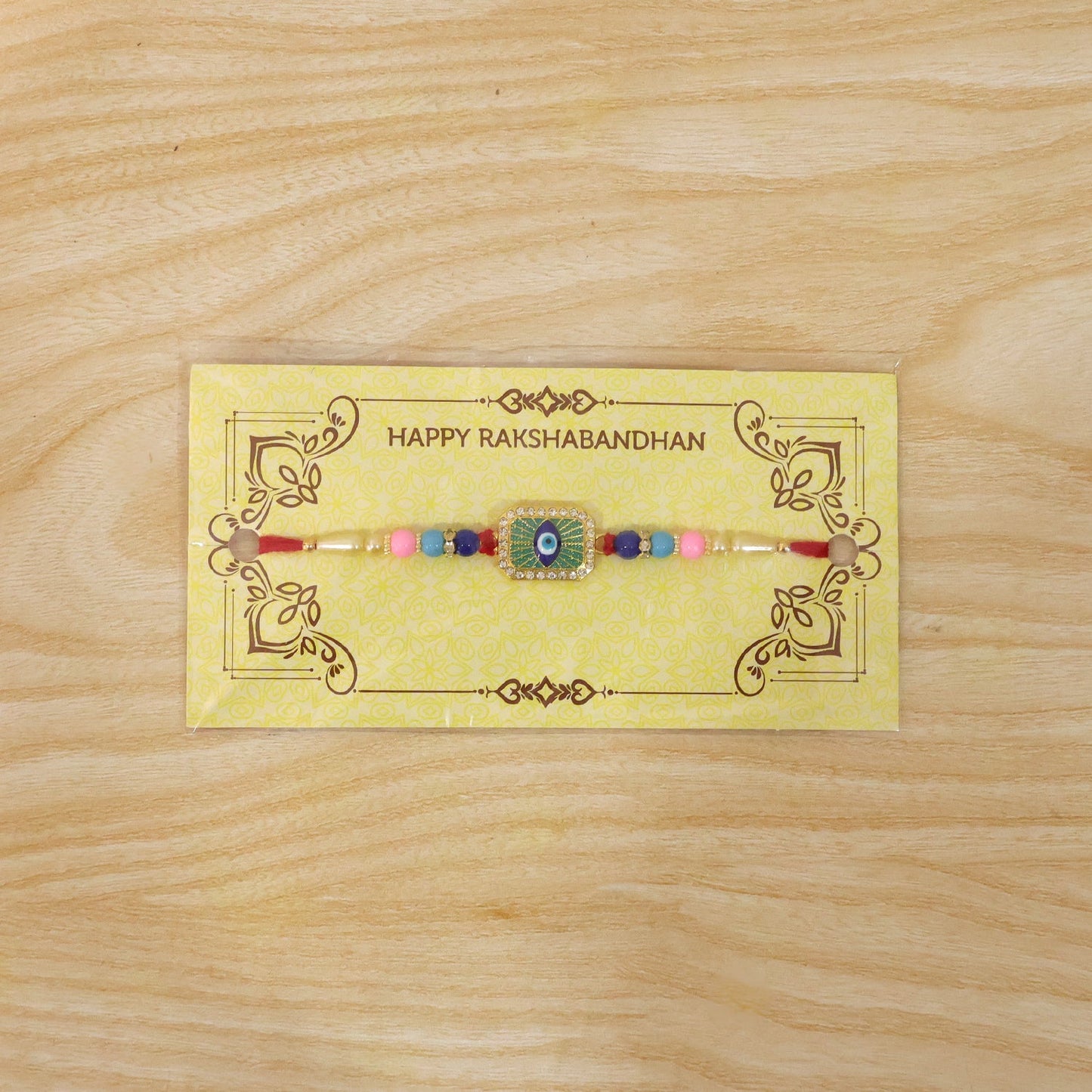 Elegant mint green thread Rakhi with decorative beads