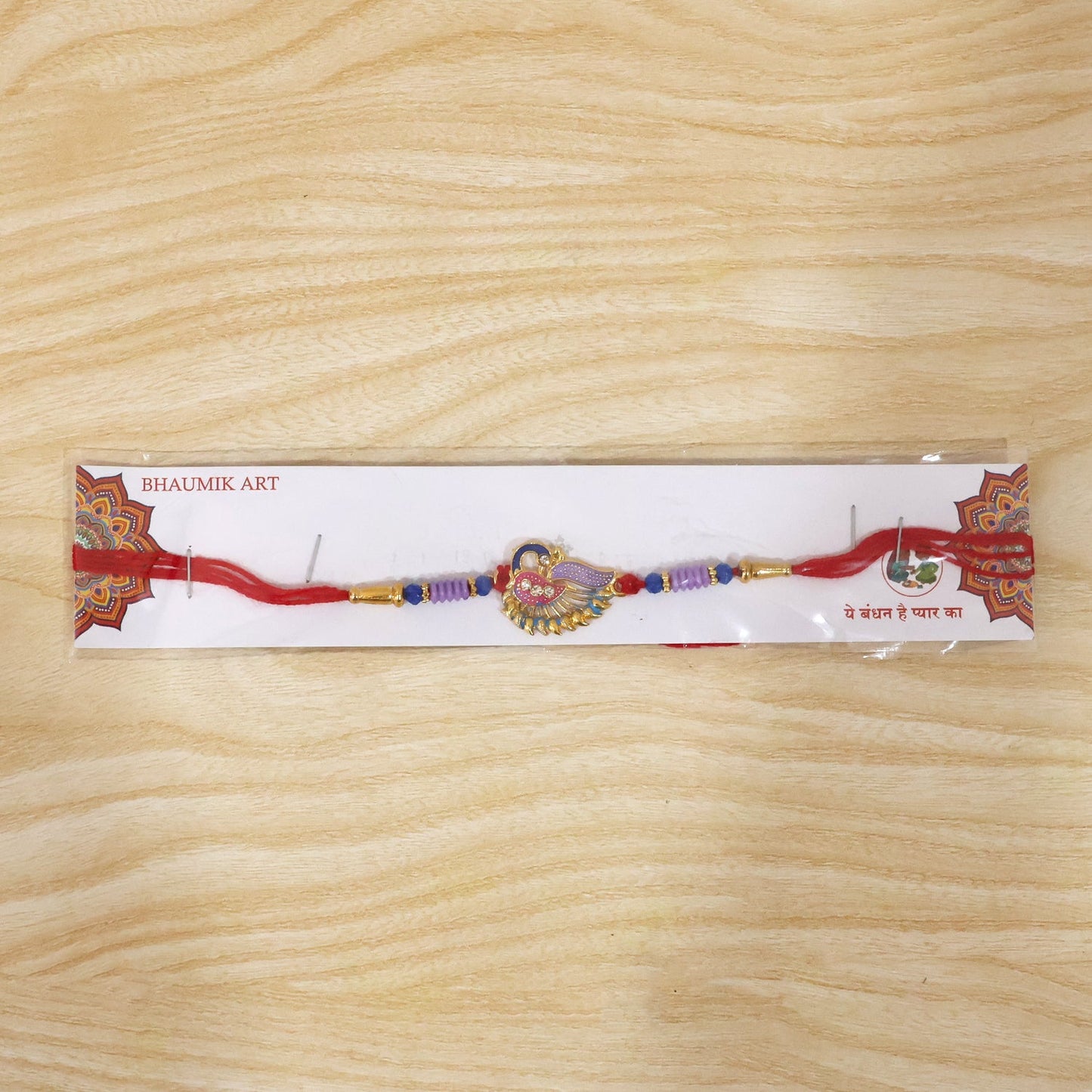 Elegant designer Rakhi with peacock motif and beads