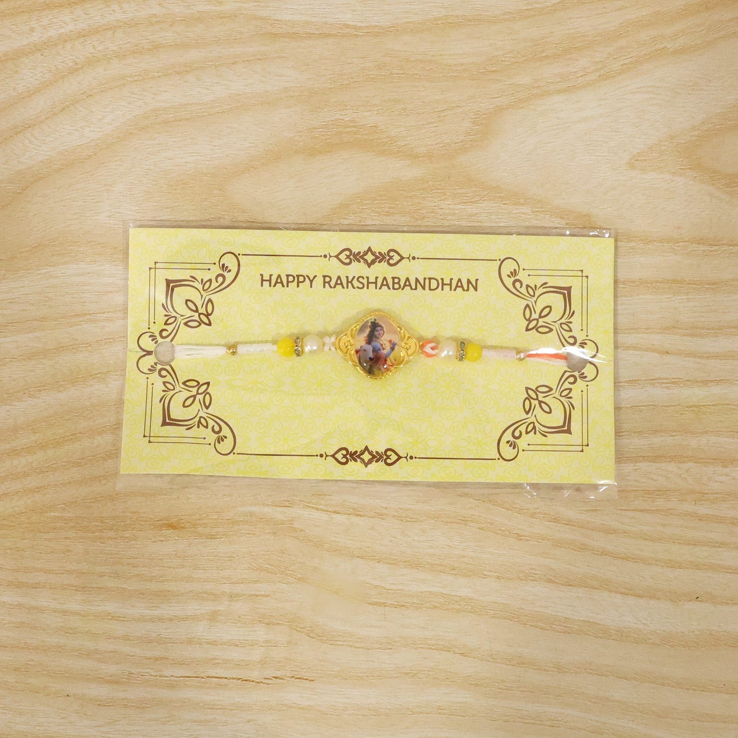 Beautiful Rakhi with Lord Krishna image and bead detailing