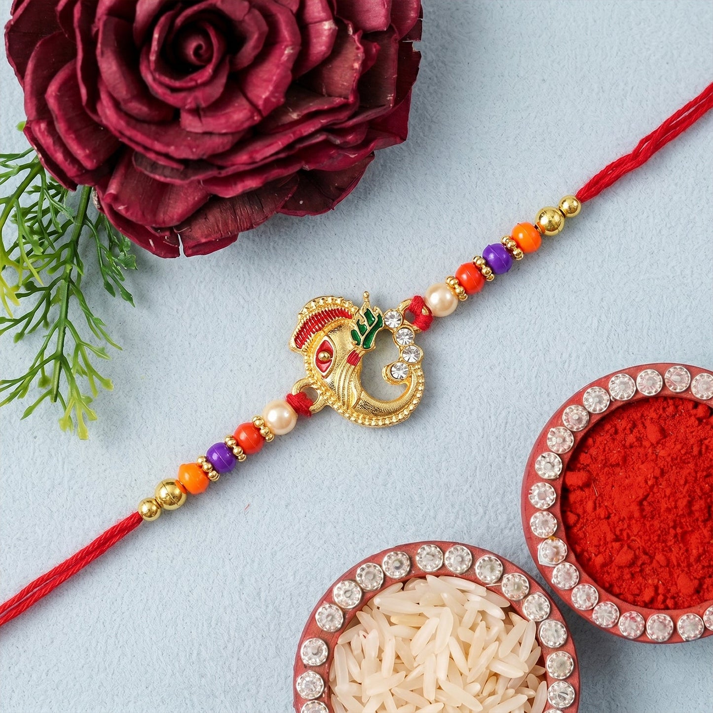 Traditional Ganesh Rakhi with decorative beads for Rakshabandhan