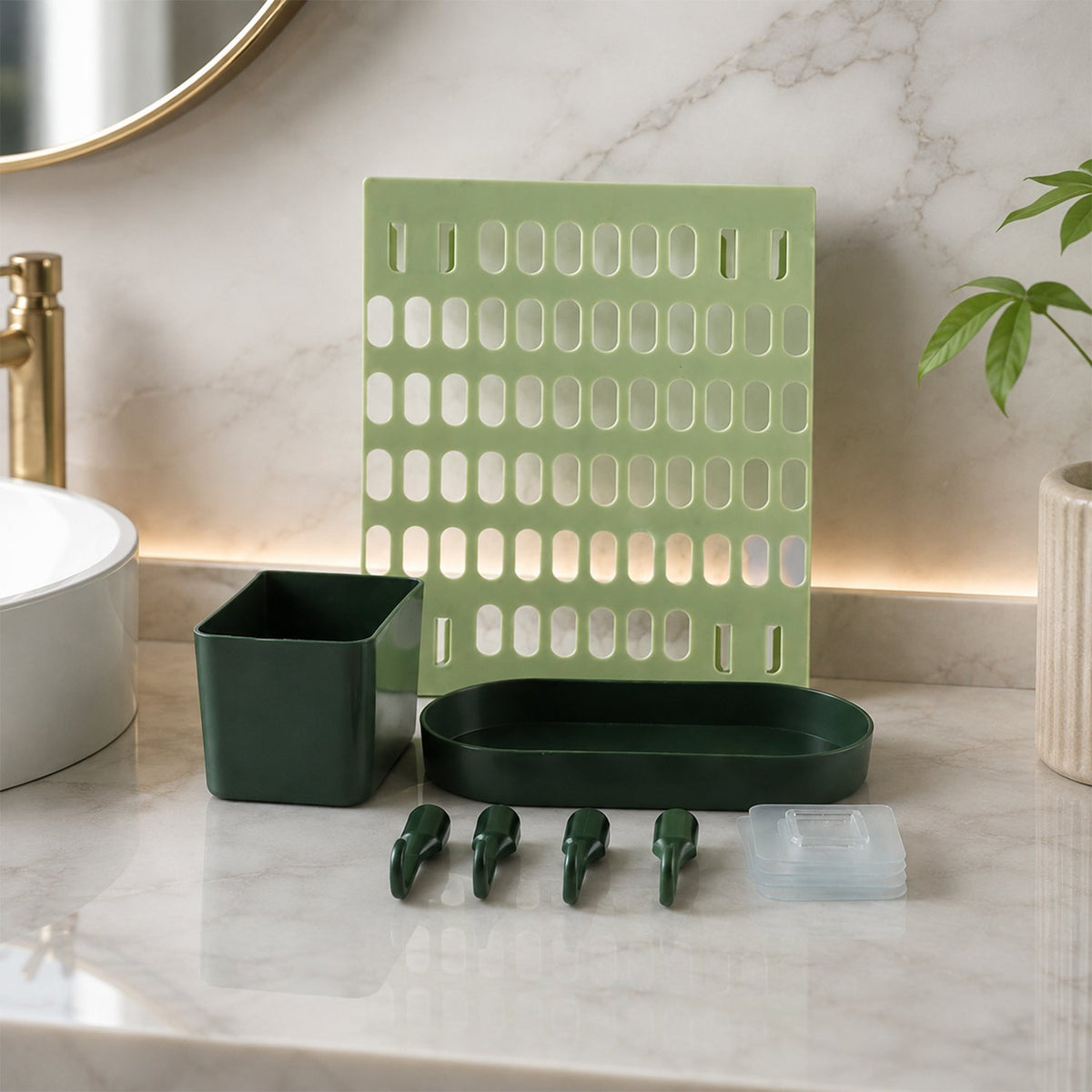 A light green pegboard, a dark green square cup, an oval tray, four hooks, and clear adhesive pads on a marble counter with
