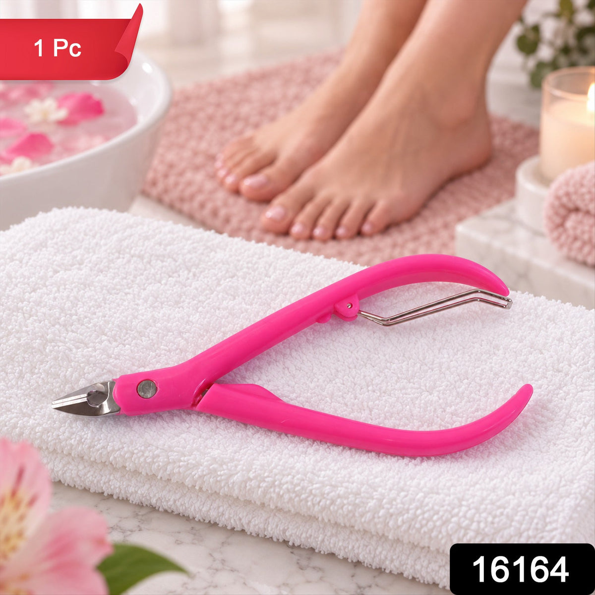 A pink cuticle nipper with metal blades lies on a white towel, with a foot bath and feet in the background.