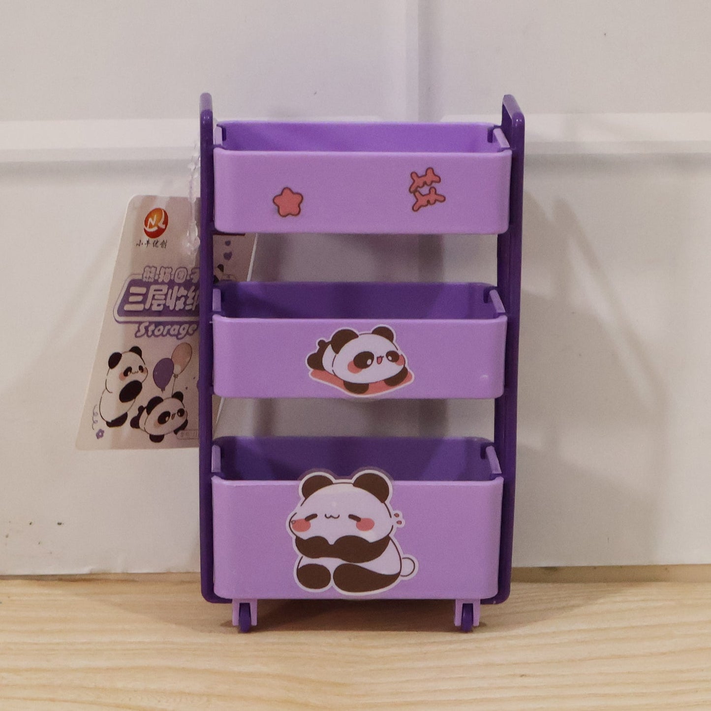 Purple mini storage trolley holding cosmetics and daily essentials on a dressing table.
