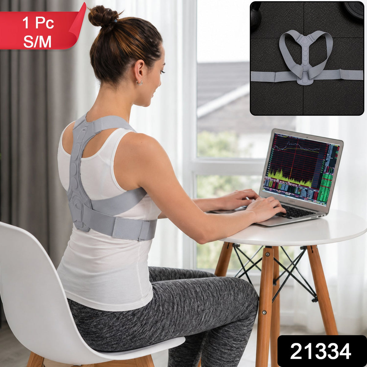 Woman wearing a grey posture corrector working on a laptop, with text overlays indicating size S/M and product number 21334.