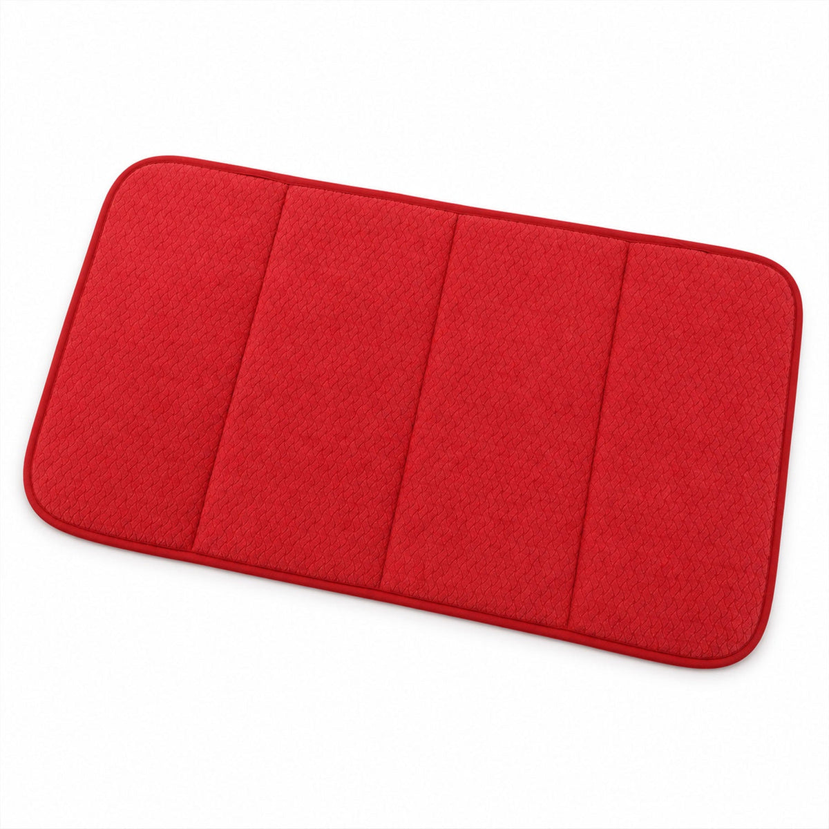 A red rectangular bath mat with four distinct padded sections and a subtle woven texture, viewed from above on a white